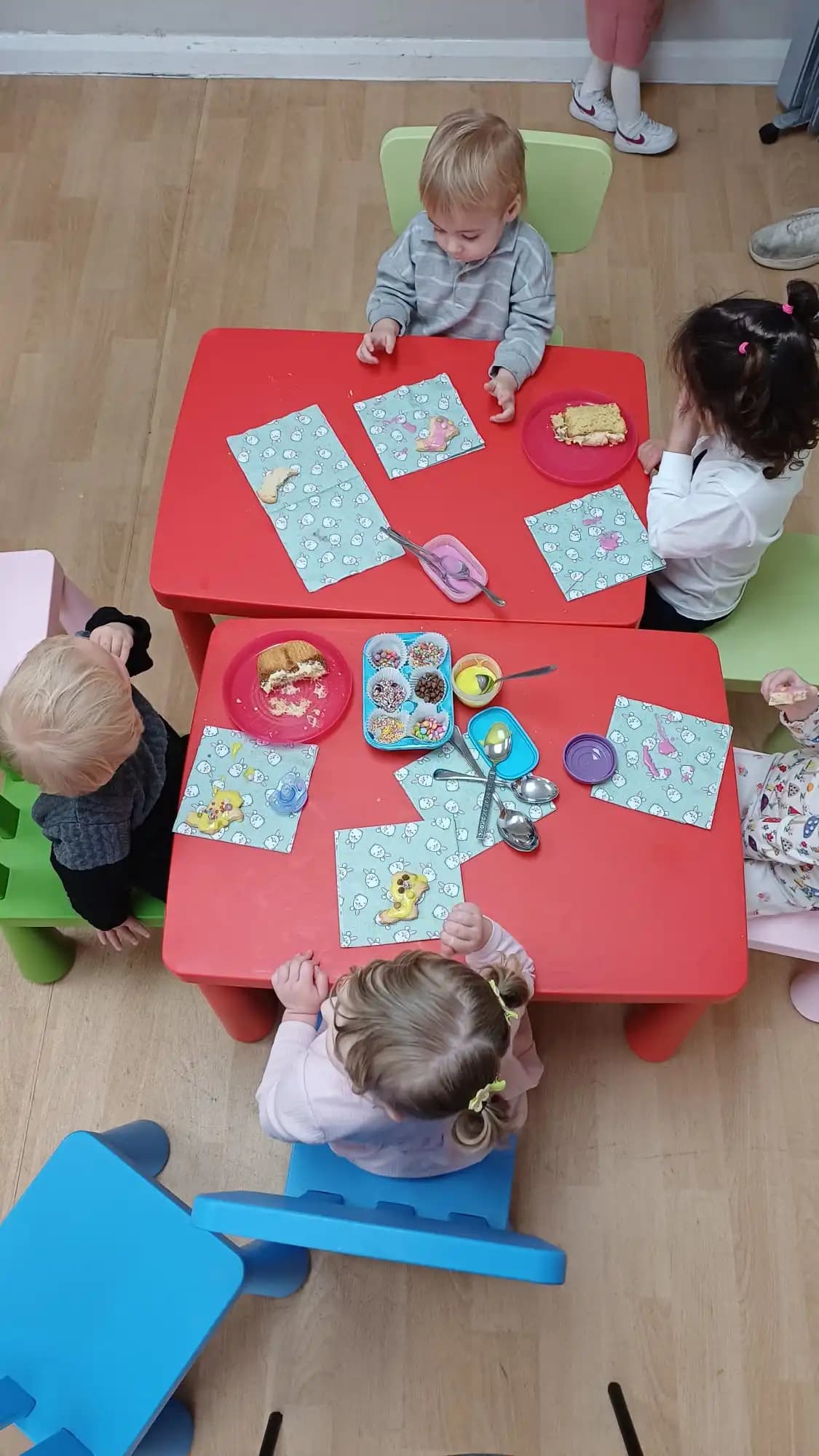 Children gathered around a table, laughing and learning together
